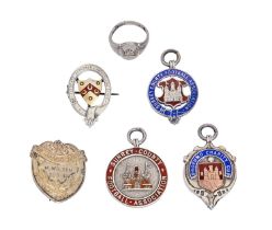 Four silver watch fob shields, three enamelled, a similar badge and a platinum coloured metal signet
