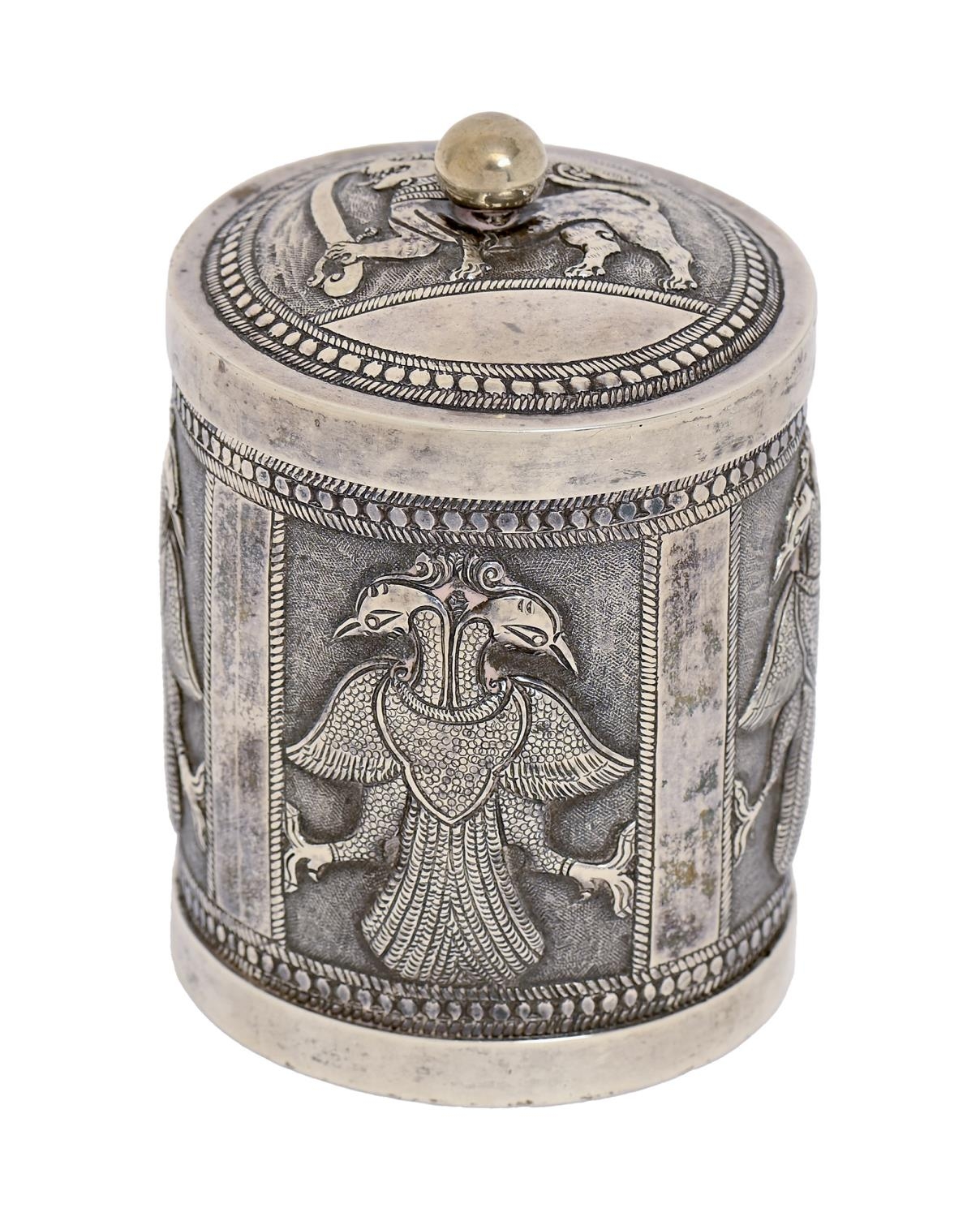 A Burmese silver repousse cigarette canister and cover with detachable base, first half 20th c,