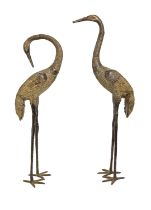 A pair of bronze Japanese crane harden sculptures, 20th c, uneven black patina, 100cm h