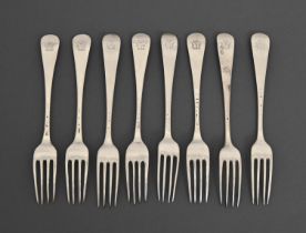 A composed set of eight George II silver table forks, crested, marks rubbed, London 1746 and