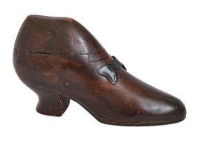 Treen. A carved and stained wood shoe novelty table snuff box, with painted metal bow, 20.5cm l