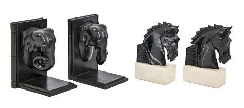 A pair of carved stone horse’s head bookends, on marble plinth, 18cm h and a pair of ebonised