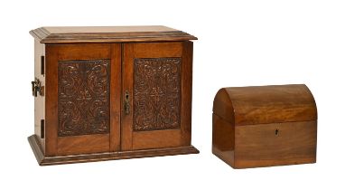 A Victorian oak smoker's cabinet, with carved panelled doors and brass handles, the fitted