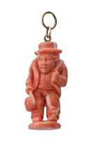 A coral pendant, c1900, carved in the form of a hunchback, suspended from gold loop, 41mm h Repaired