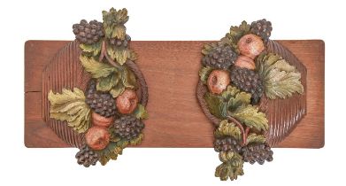 An Edwardian polychrome walnut book rest, the hinged ends in the form of fruit filled baskets,