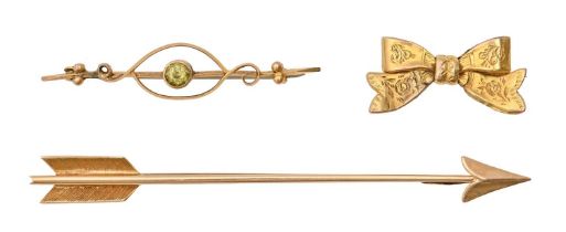 A gold Cupid's dart brooch, c1930, 76mm l, marked 15ct, 4.8g, a Victorian 9ct gold bow brooch and