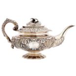 An Irish George IV silver teapot, crisply chased with flowers and shells, the domed lid with