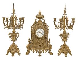 An Italian pierced brass clock garniture, in Louis XVI style, the enamel dial indistinctly signed,