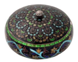 A Middle Eastern silver and enamel box and cover, decorated with stylised leaves, 68mm diam,