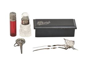 A Victorian silver capped ruby glass scent bottle, 66mm h, unmarked, a silver butterfly hair comb,