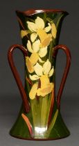 A Longpark Torquay Pottery Art Nouveau three handled vase, decorated with daffodils, 26cm h Good