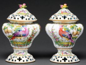 A pair of French porcelain pierced ogee pot pourri vases and covers, first half 20th c, painted with