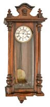 A walnut Vienna wall clock, c1930, giltmetal mounted enamel dial, weights and pendulum, 118cm h x