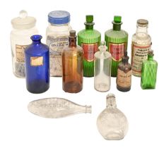 A quantity of Victorian and later glass bottles and jars, including a pair of green glass chemist'