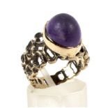 A 1970's yellow metal amethyst set dress ring.