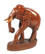 A large 20th century carved teak model of an elephant.