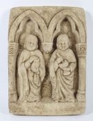 A wall hanging plaster cast plaque. Depicting two medieval monks within an arched church recess, 28.