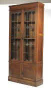 An early 20th century oak lead glazed free standing cabinet.