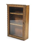 An early 20th century rustic oak glazed wall cabinet. With two internal velvet lined shelves.