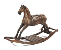 A carved wooden rocking horse on fixed base.
