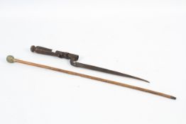 A 20th century swagger stick and modified socket bayonet.