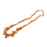 A Baltic amber large baroque shaped and tumble polished necklace.