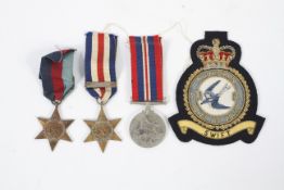 Three WWII medals and a RAF swift squadron cloth badge.
