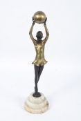 An Art Deco painted spelter figure of a lady with a ball after Joseph Lorenzel.