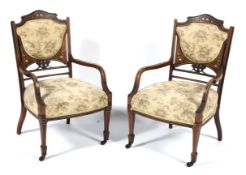 A pair of Edwardian inlaid mahogany bedroom chairs.