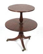 An Edwardian mahogany two tier pedestal dumb waiter with dropleaf tiers.