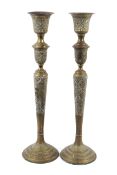 A pair of brass Islamic candle stands.