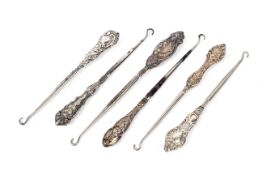 A collection of six late 19th century silver handled button hooks.