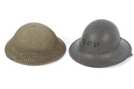 Two mid-century military helmets. One being marked and dated BMB 1941.