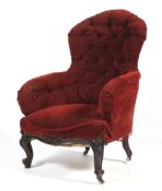 A Victorian button back rise and fall elbow chair. With sprung back rest and arms.