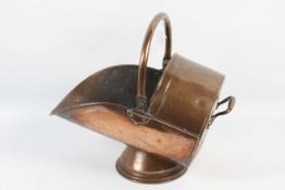 A Victorian helmet copper coal scuttle.