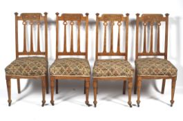 A set of four oak Arts and Crafts dining chairs.