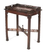 An Edwardian mahogany butlers tray table. The twin handled tray with all round pierced gallery rail.