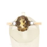A citrine and zirconia dress ring. Hallmarked 375, size O.