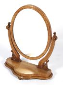 A Victorian satinwood oval dressing table swing mirror.