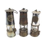 Three miner's lamps.