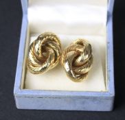 A pair of yellow metal knot earrings. Weight 4.