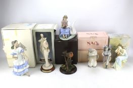 A collection of Nao and other ceramic figures.