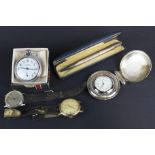 An assortment of watches and a silver pencil.