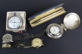 An assortment of watches and a silver pencil.