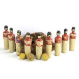 A set of eight novelty wooden skittles. Painted as Kings Guards, H19.