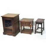 An oak side cabinet, a single drawer oak side table and an oak stool.