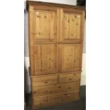 A contemporary pine wardrobe chest.