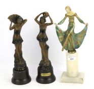 Three bronzed Art Deco style figures.