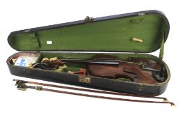An early 20th century violin with two violin bows in wooden travel box.