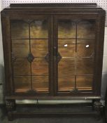 A 20th century carved wooden display cabinet.